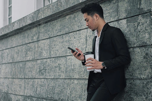 A man wearing watch with leather watch strap