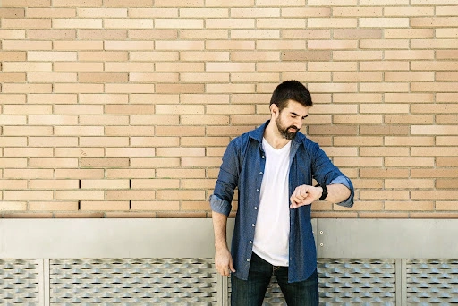 A man looking at his watch